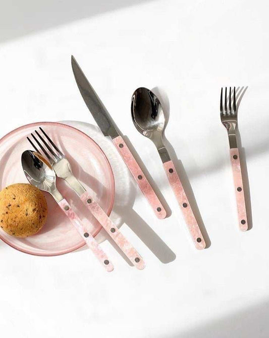 10-piece sleek modern pinky flatware set with stainless steel utensils and pink handles on white background